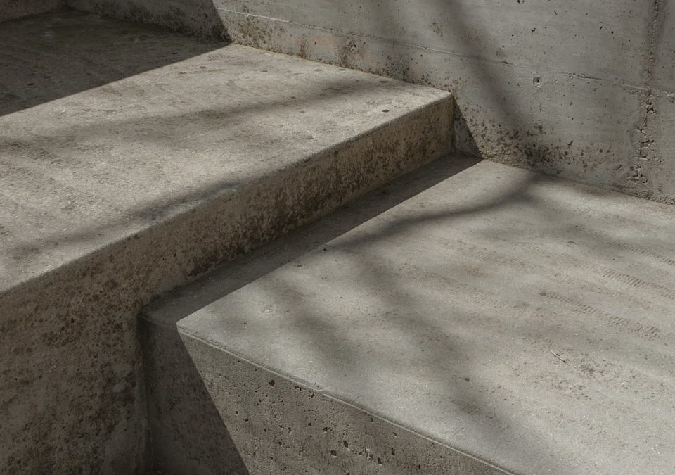 a concrete bench sitting next to a cement wall